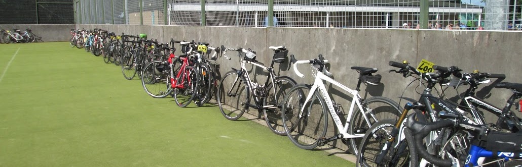 Bikes are securely parked in the tennis courts compound